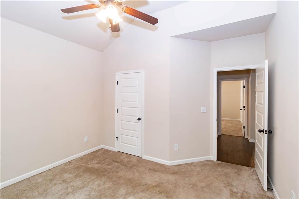 70 Sylvan Loop Fayetteville, GA 30214 - Photo 17 of 40 an empty room with closet and a chandelier fan