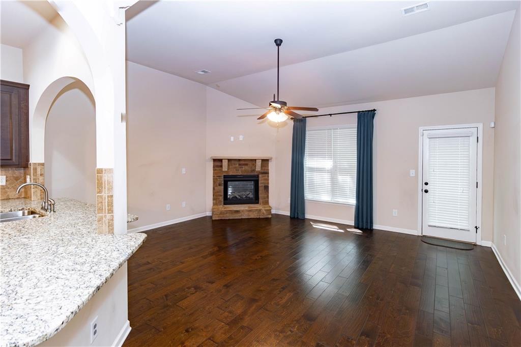 70 Sylvan Loop Fayetteville, GA 30214 - Photo 19 of 40 a view of an empty room with a fireplace and wooden floor