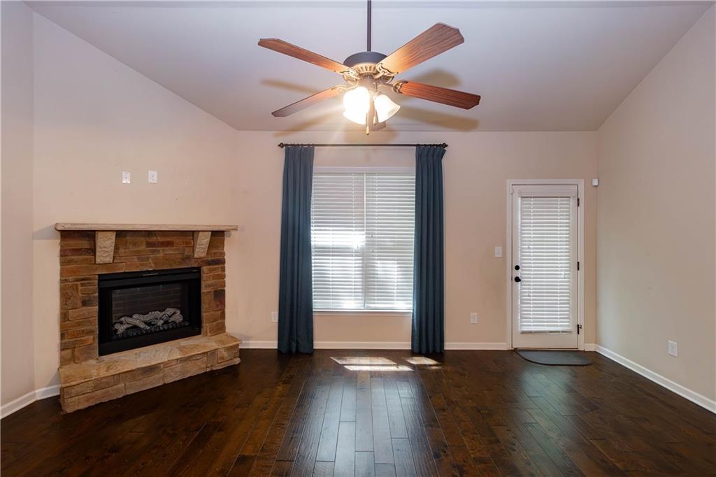 70 Sylvan Loop Fayetteville, GA 30214 - Photo 20 of 40 a view of an empty room with wooden floor fireplace and a window