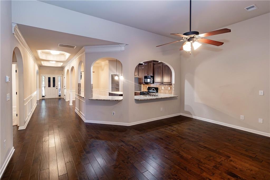 70 Sylvan Loop Fayetteville, GA 30214 - Photo 21 of 40 a view of a room with wooden floor furniture and a ceiling fan