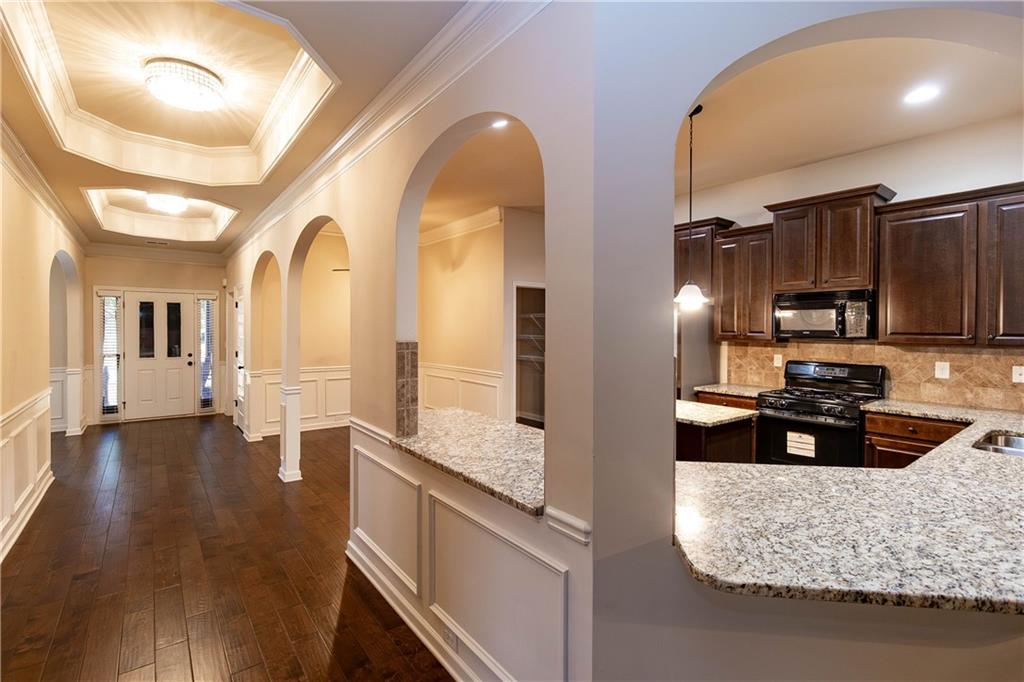 70 Sylvan Loop Fayetteville, GA 30214 - Photo 22 of 40 a kitchen with kitchen island granite countertop a stove and cabinets