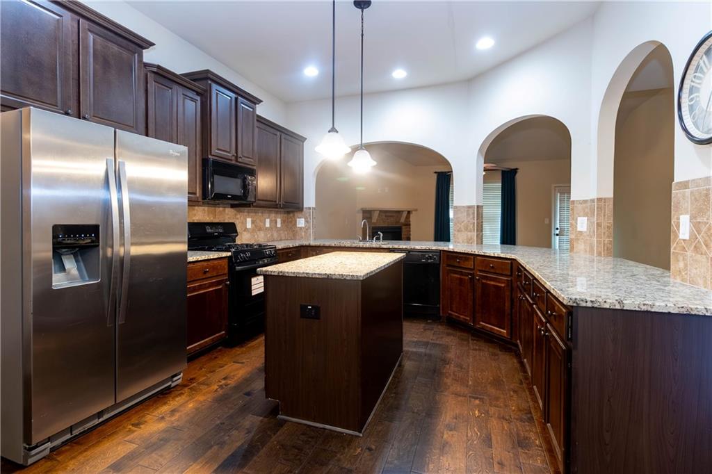70 Sylvan Loop Fayetteville, GA 30214 - Photo 24 of 40 a kitchen with stainless steel appliances granite countertop a sink a refrigerator and a wooden floor