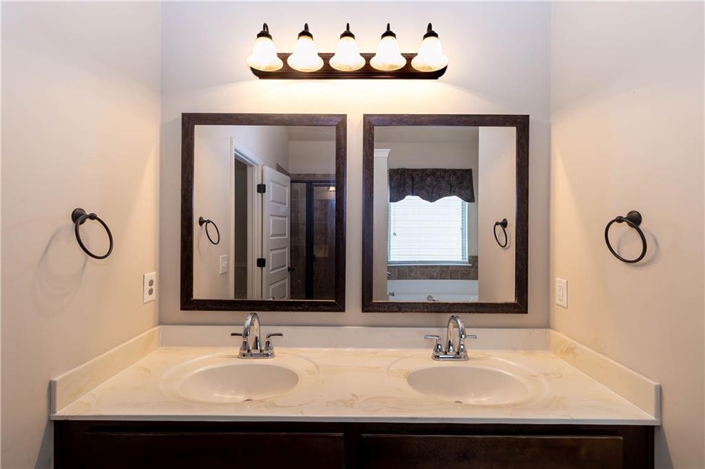 70 Sylvan Loop Fayetteville, GA 30214 - Photo 35 of 40 a bathroom with a sink vanity and a mirror