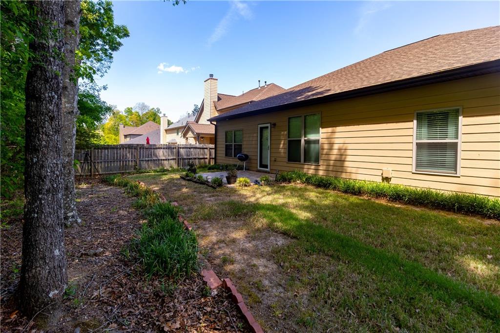 70 Sylvan Loop Fayetteville, GA 30214 - Photo 38 of 40 a backyard of a house with garden and outdoor seating