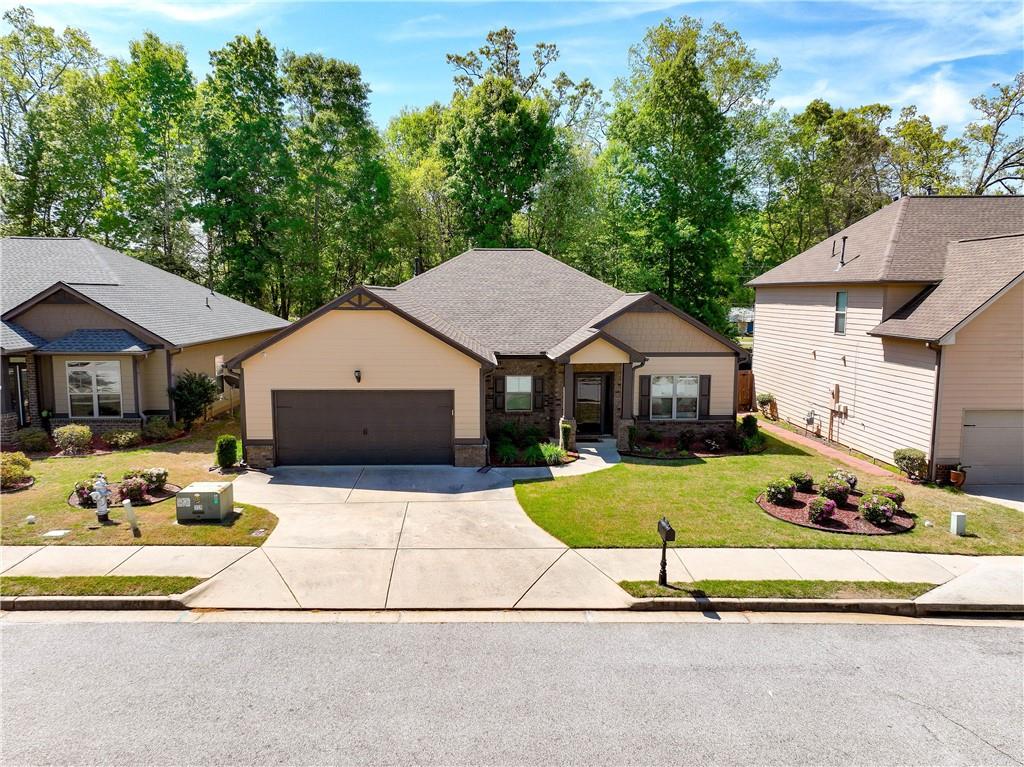 70 Sylvan Loop Fayetteville, GA 30214 - Photo 6 of 40 a front view of a house with a yard and garage