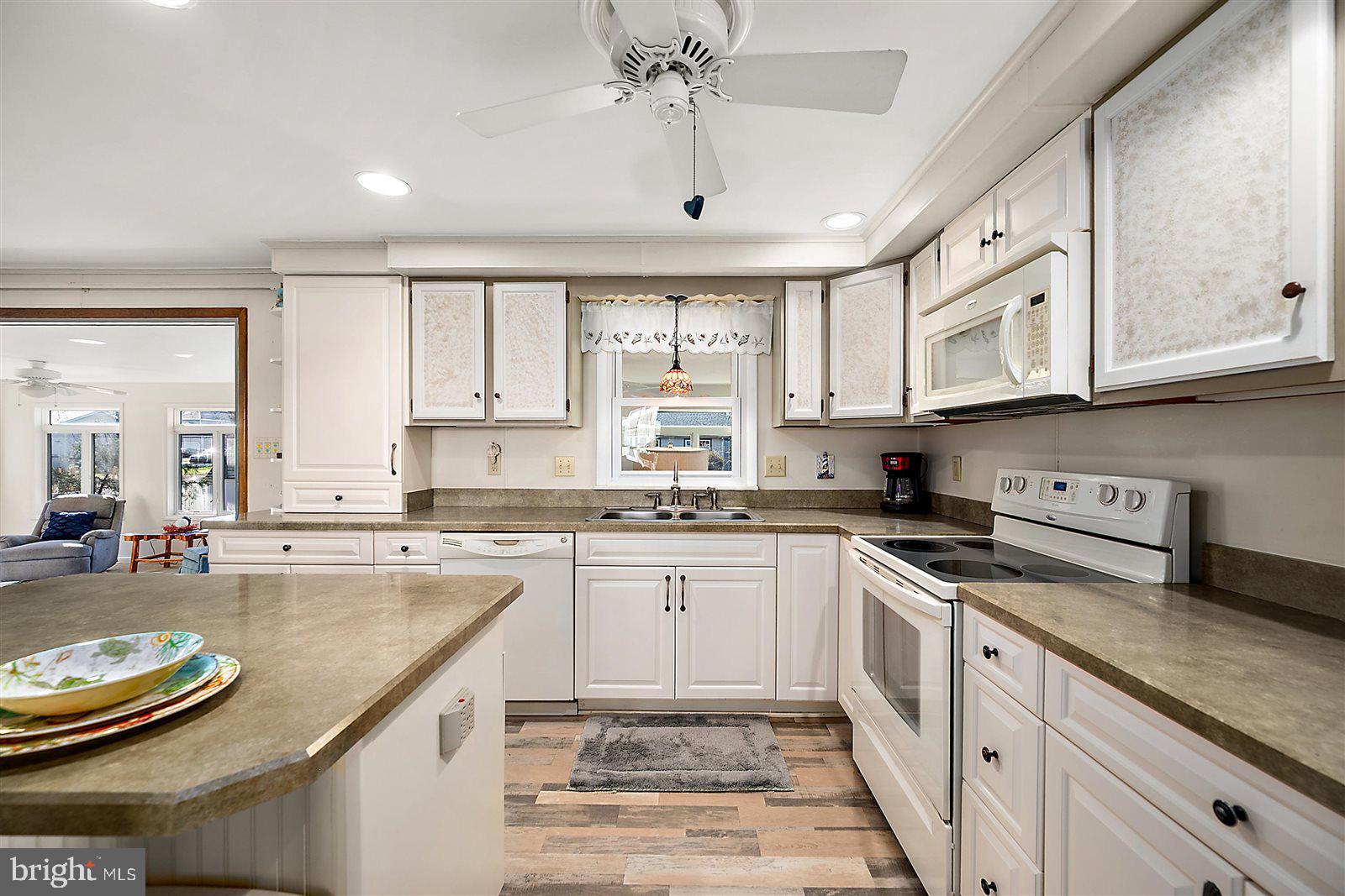 12 Windmill Lane Ocean View, DE 19970 - Photo 11 of 54 a kitchen with stainless steel appliances granite countertop a stove a sink and cabinets