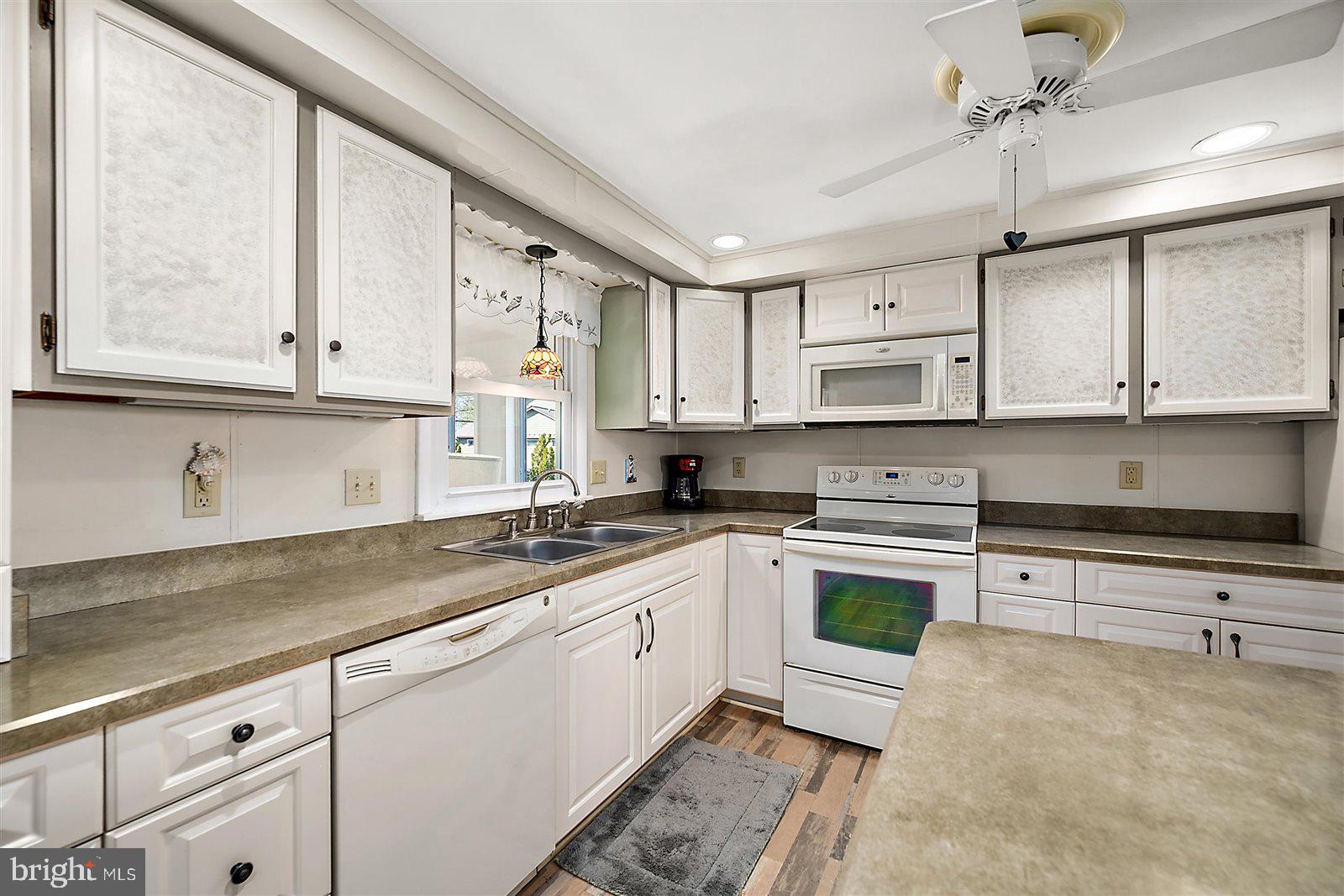 12 Windmill Lane Ocean View, DE 19970 - Photo 14 of 54 a kitchen with stainless steel appliances granite countertop a sink a stove and cabinets