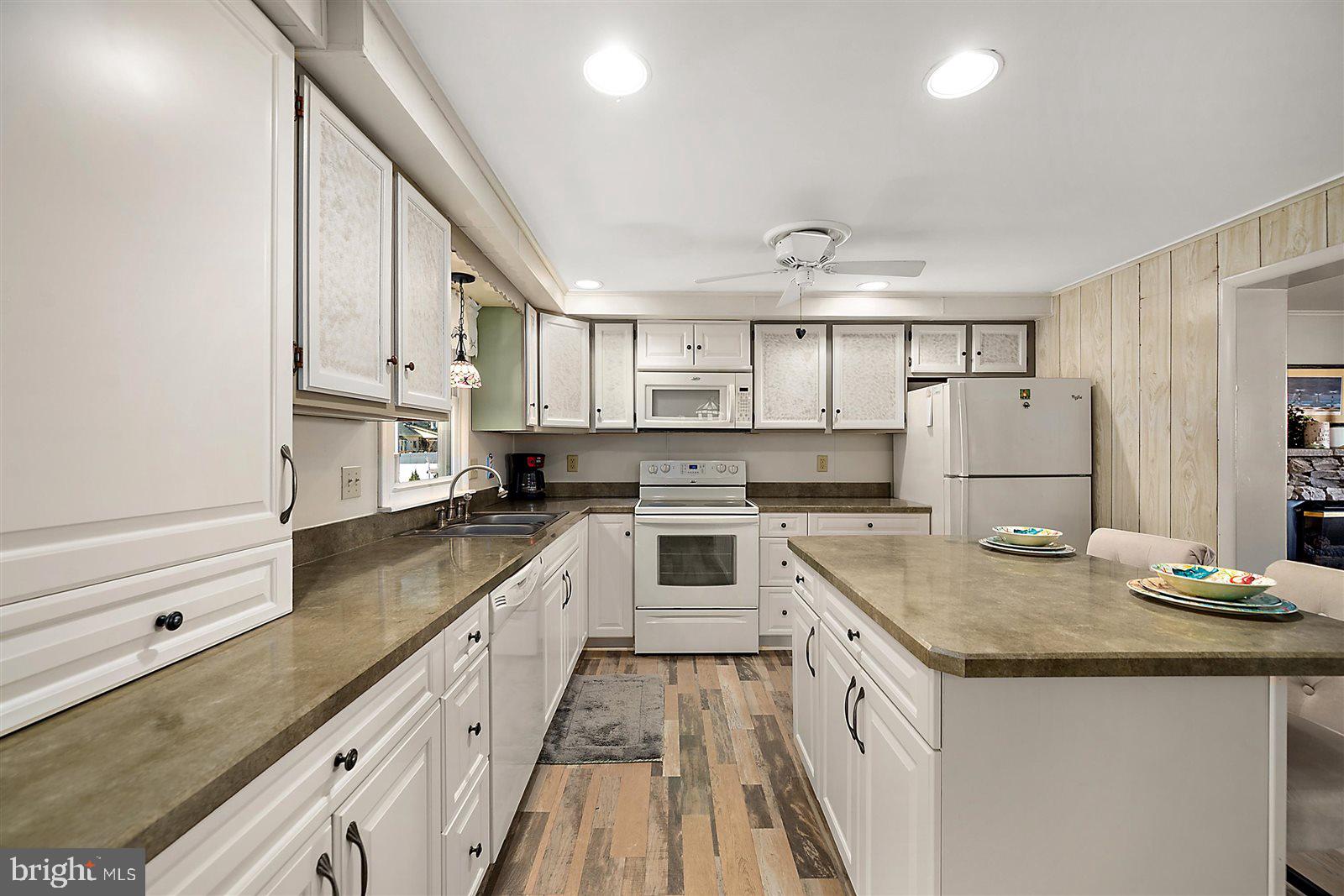 12 Windmill Lane Ocean View, DE 19970 - Photo 15 of 54 a kitchen with granite countertop a sink and cabinets