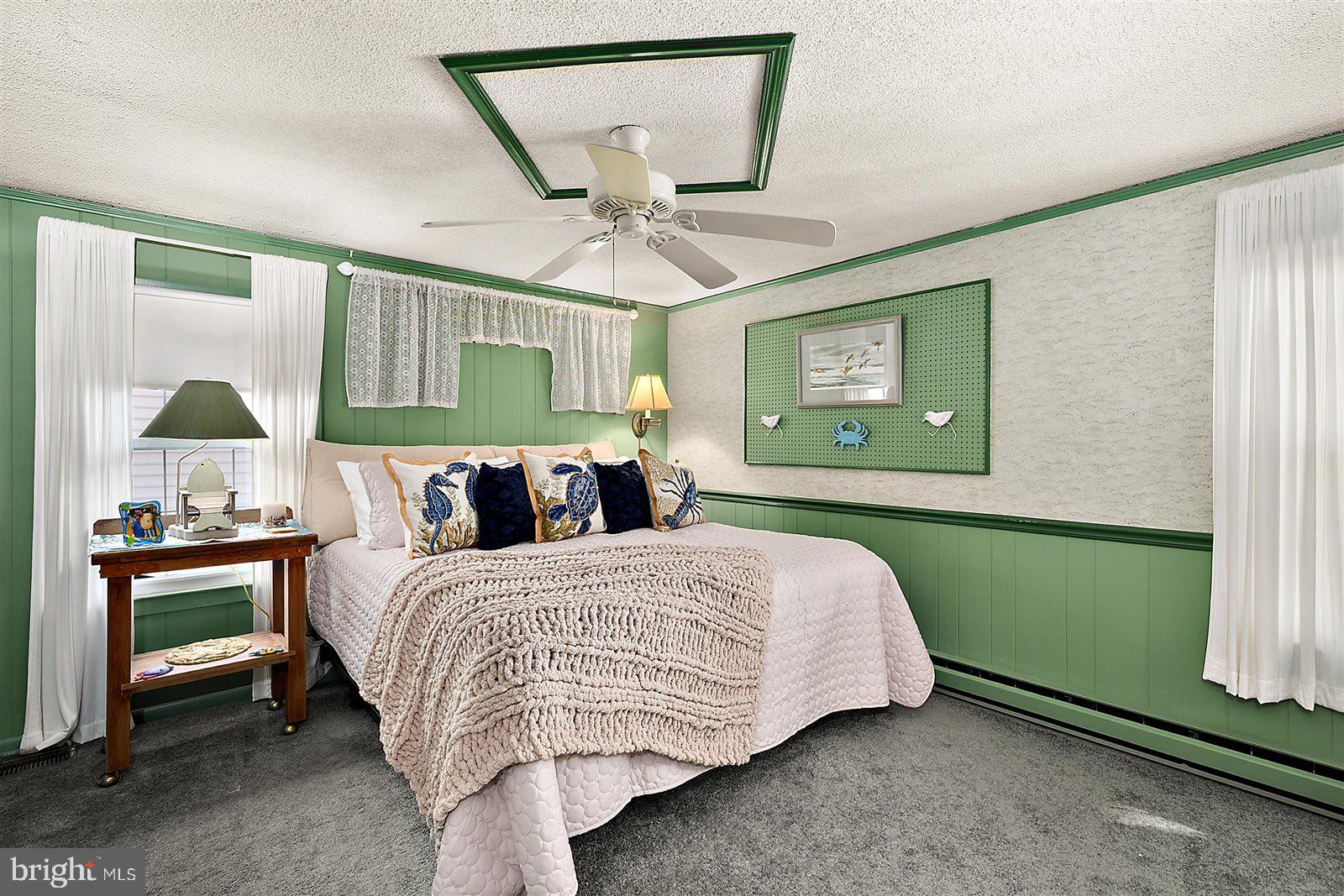 12 Windmill Lane Ocean View, DE 19970 - Photo 19 of 54 a bedroom with a bed and a chandelier