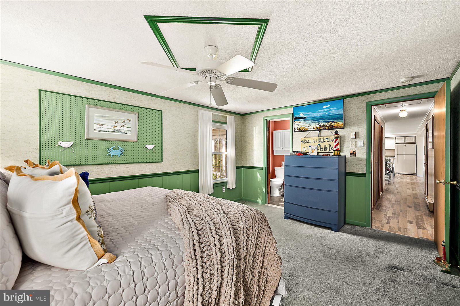 12 Windmill Lane Ocean View, DE 19970 - Photo 20 of 54 a bedroom with a bed and a chandelier