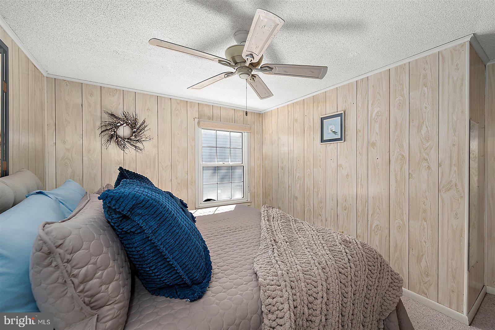 12 Windmill Lane Ocean View, DE 19970 - Photo 25 of 54 a spacious bedroom with a large bed and a chandelier