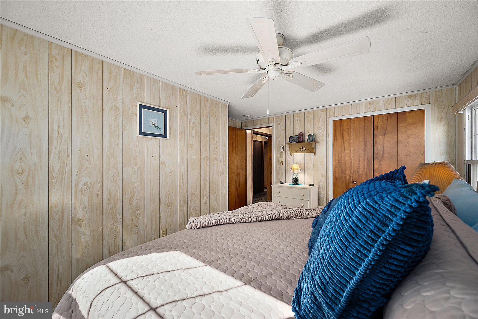 12 Windmill Lane Ocean View, DE 19970 - Photo 26 of 54 a bedroom with a large bed and a chandelier