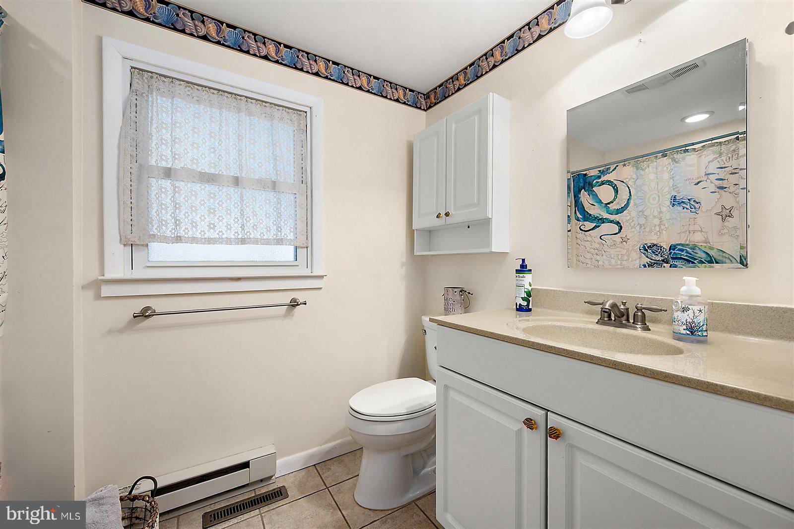 12 Windmill Lane Ocean View, DE 19970 - Photo 27 of 54 a bathroom with a sink a toilet and a mirror
