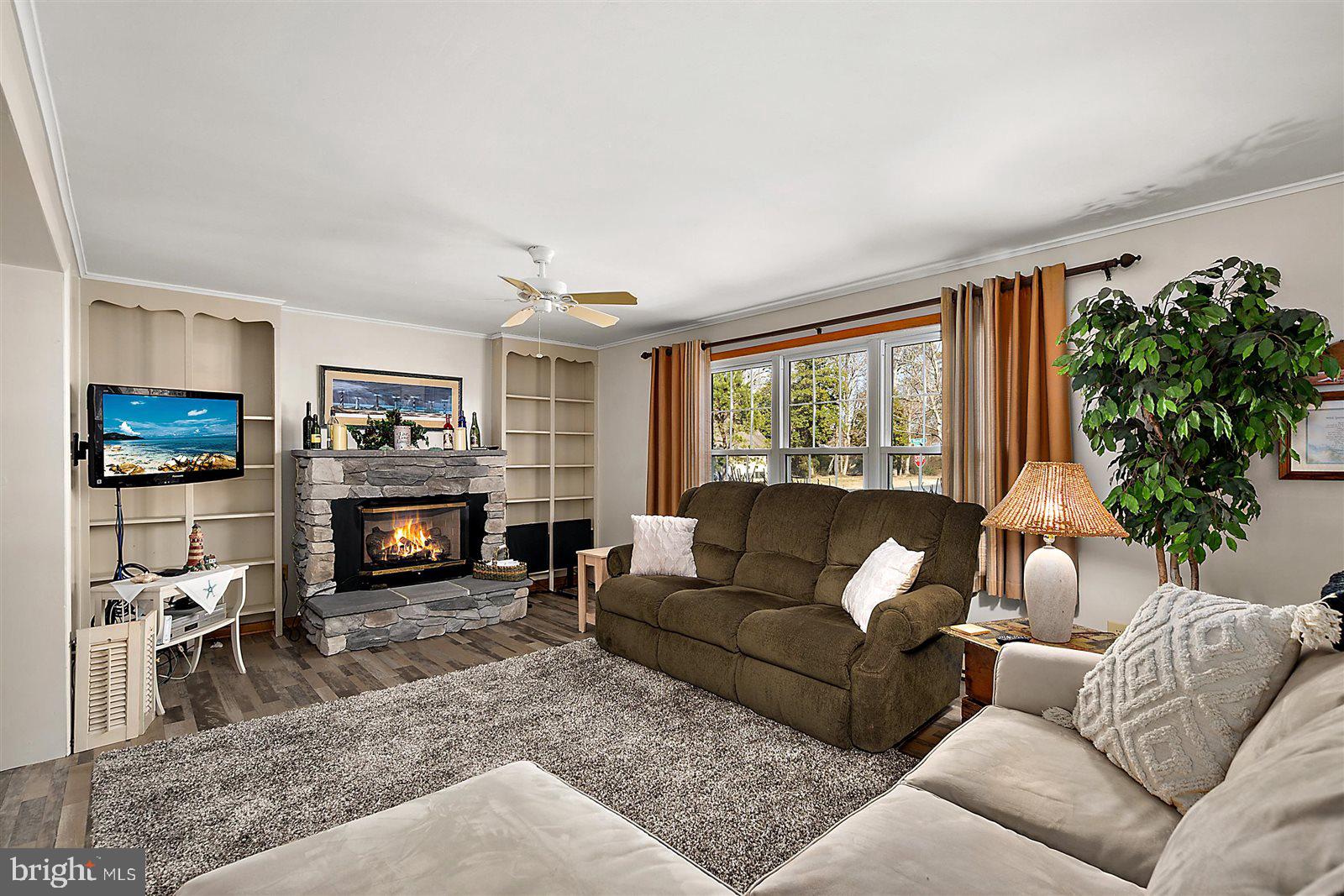 12 Windmill Lane Ocean View, DE 19970 - Photo 5 of 54 a living room with furniture a fireplace and a flat screen tv