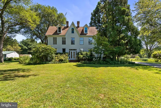 a front view of house with yard and trees