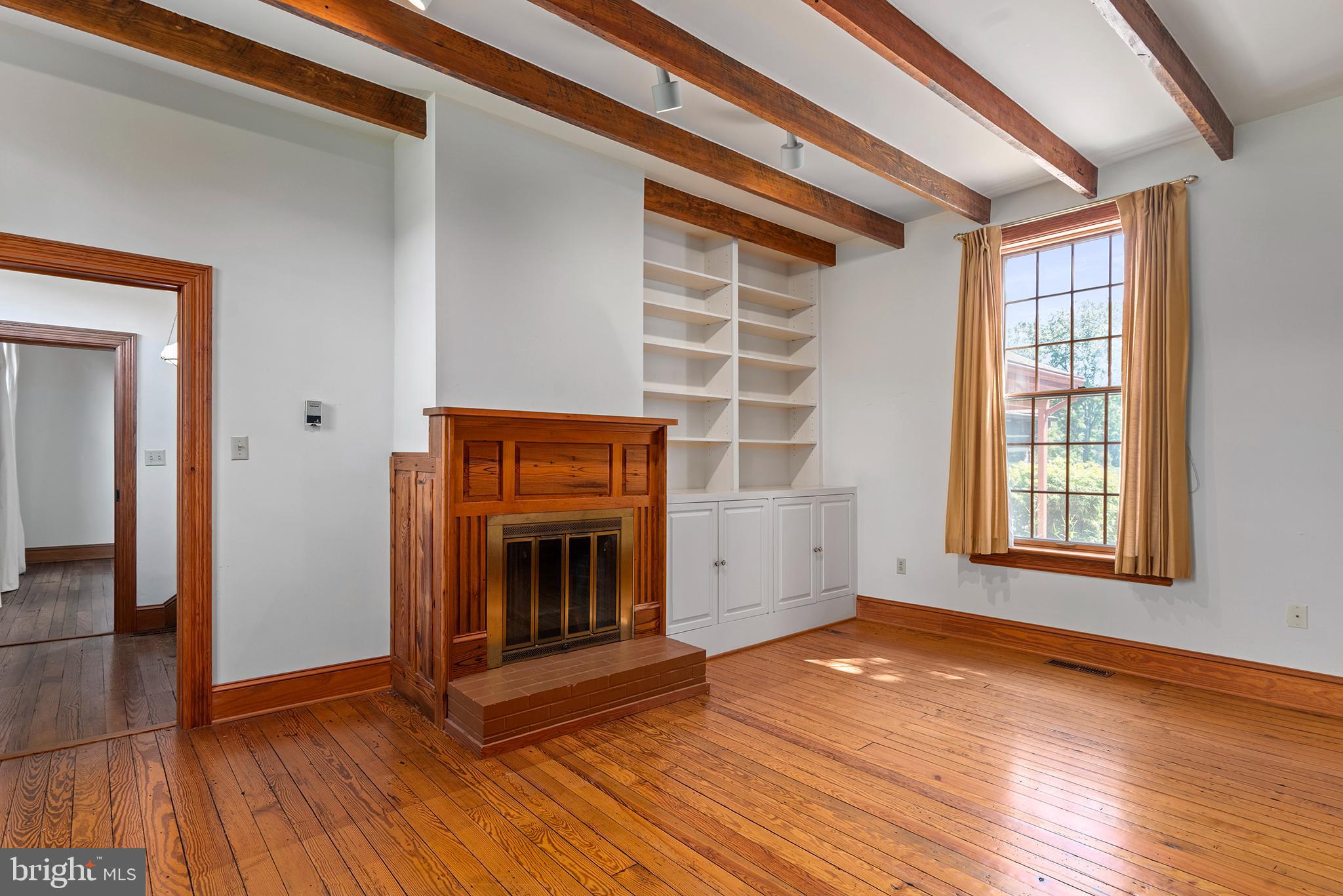 8293 Brices Mill Road Chestertown, MD 21620 - Photo 18 of 59 a view of an empty room with glass door and wooden floor