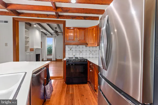 a view of a livingroom with furniture and hardwood floor