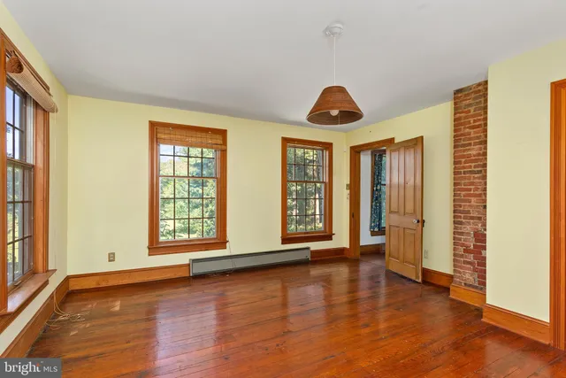 a view of entryway with wooden floor and stairs