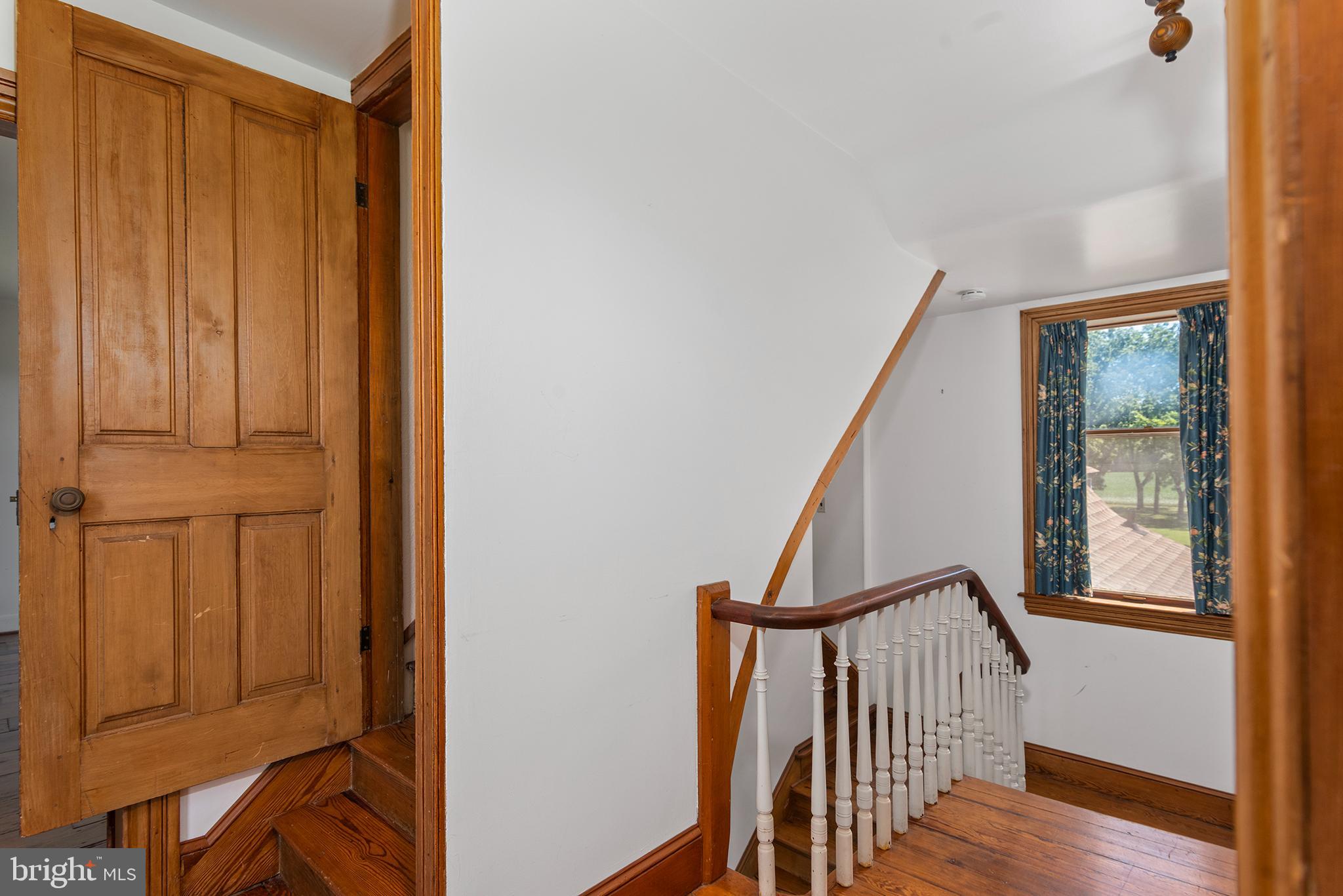8293 Brices Mill Road Chestertown, MD 21620 - Photo 38 of 59 a view of a hallway with wooden floor and staircase