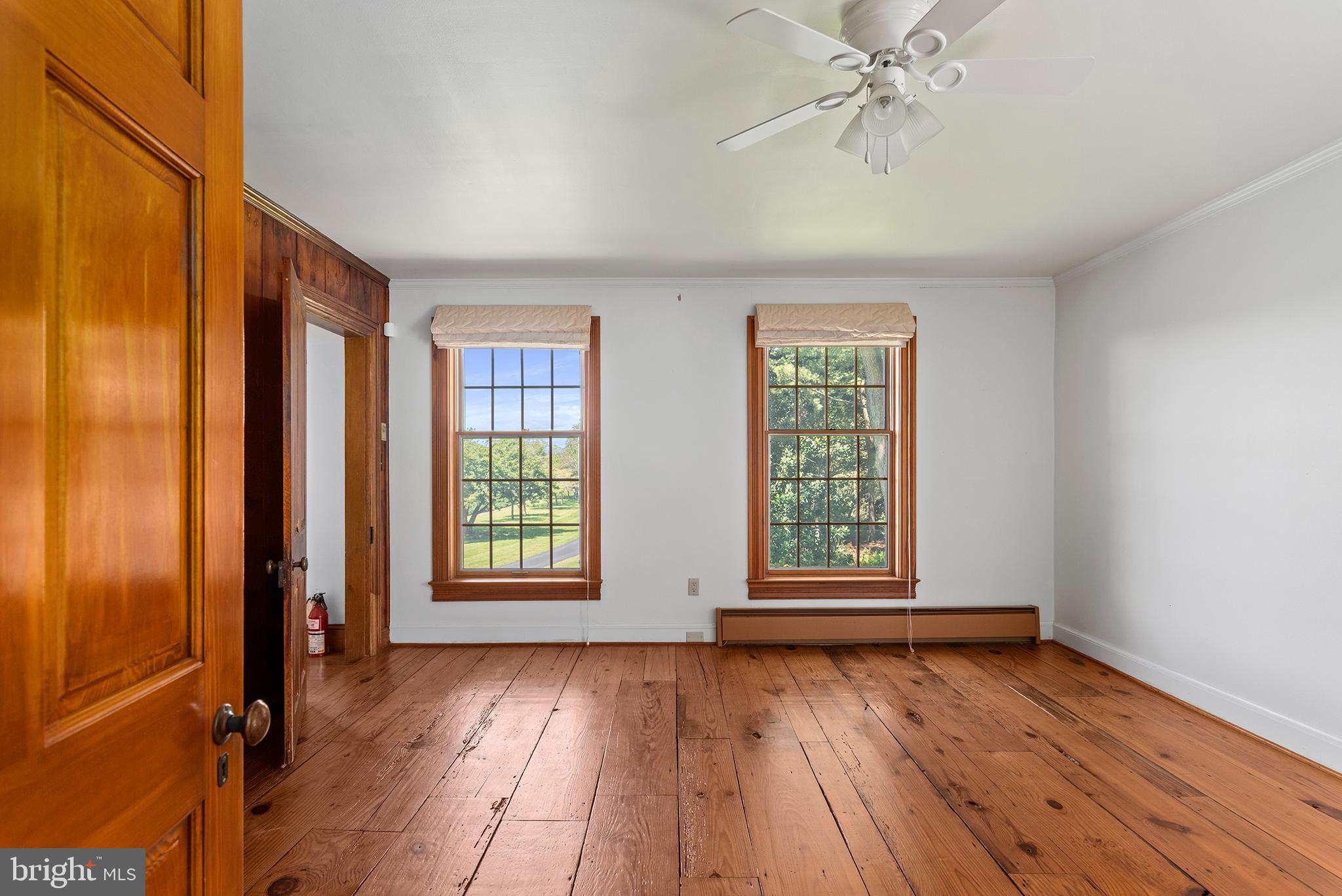 8293 Brices Mill Road Chestertown, MD 21620 - Photo 48 of 59 an empty room with wooden floor and windows