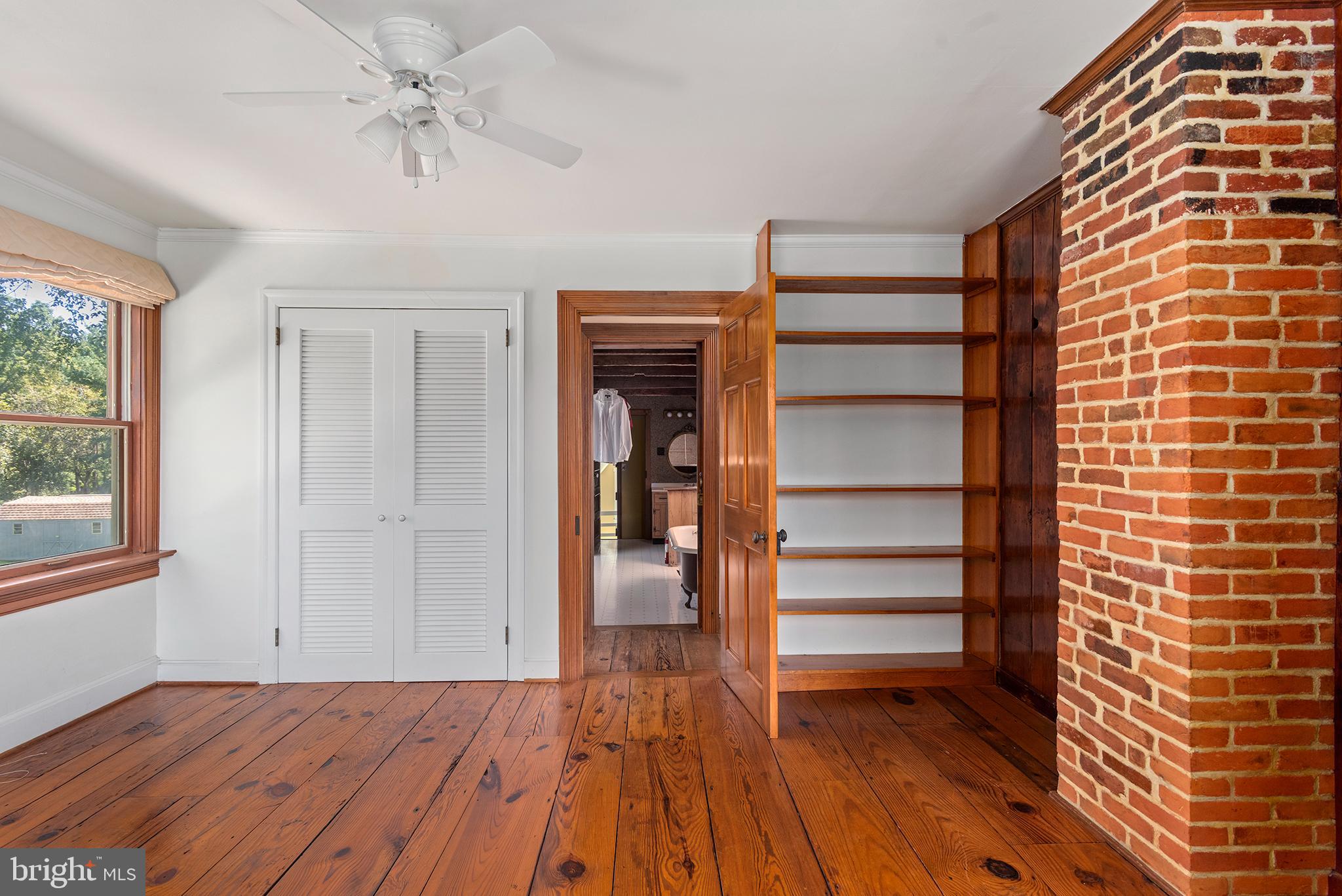 8293 Brices Mill Road Chestertown, MD 21620 - Photo 49 of 59 a view of empty room with wooden floor and fan