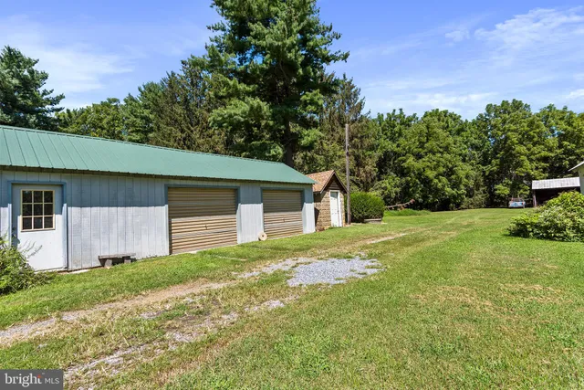 a front view of house with yard and trees