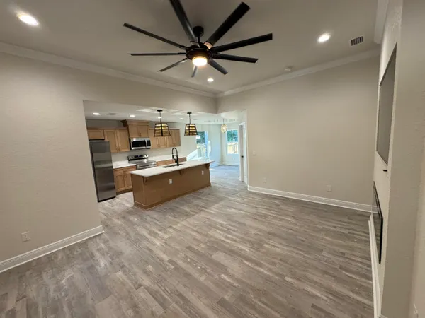 a view of a kitchen with a sink and a refrigerator