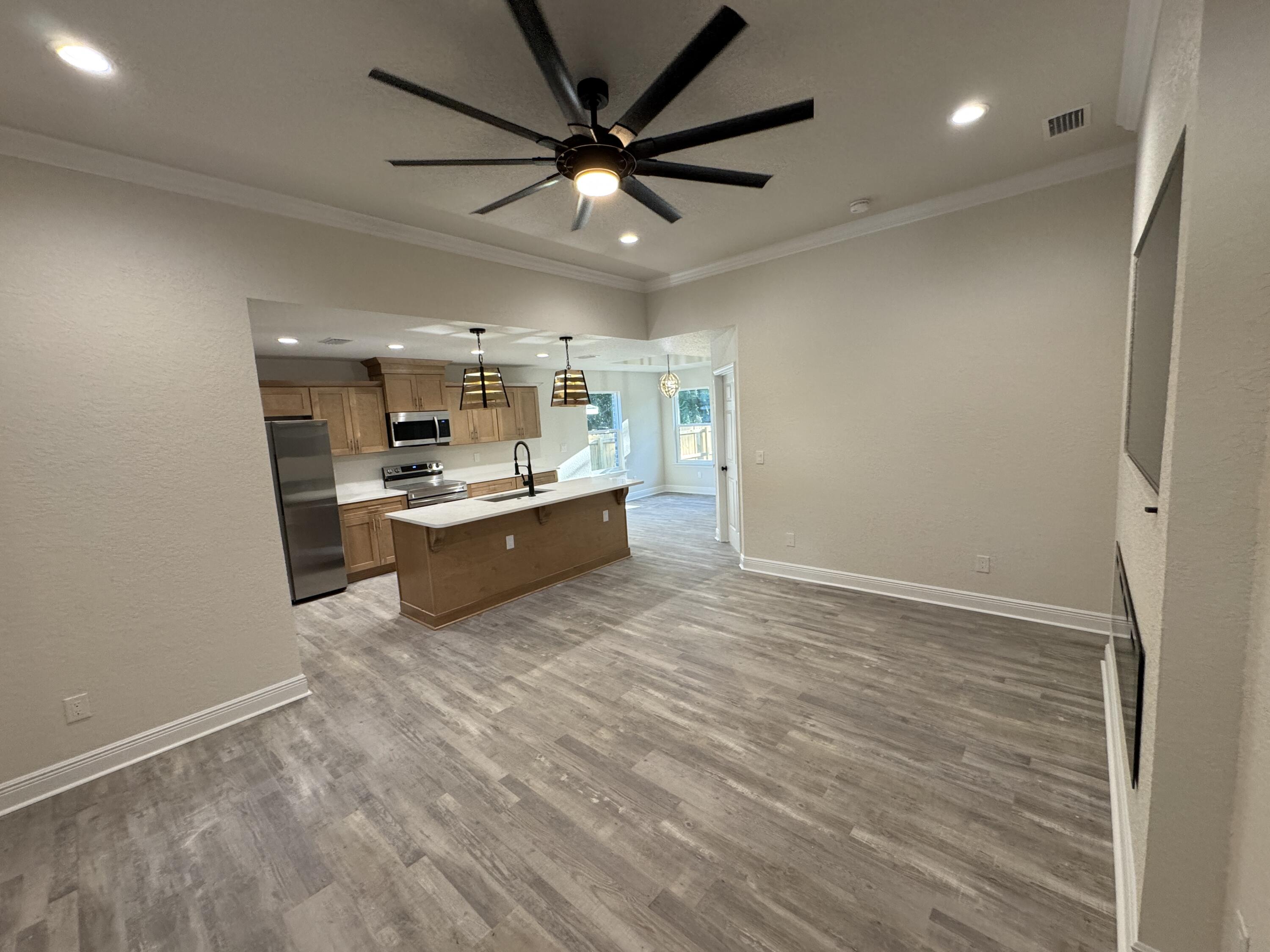 a view of a kitchen with a sink and a refrigerator