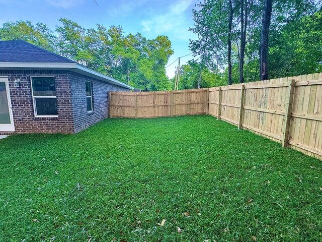 615 East Chestnut Avenue Crestview, FL 32539 - Photo 4 of 10 a view of a backyard with a garden