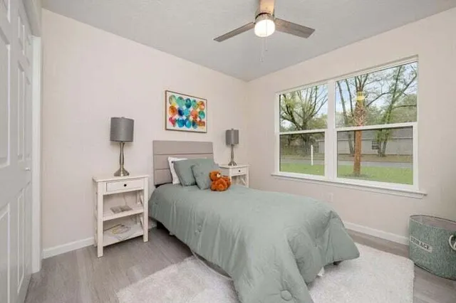 a bedroom with a bed and a window