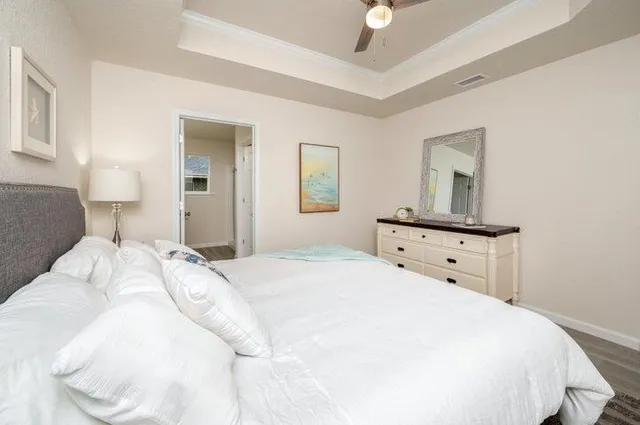 a bedroom with a bed and a night stand