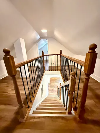 a view of entryway with stairs and wooden floor