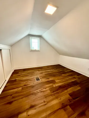 a view of water heater room with wooden floor