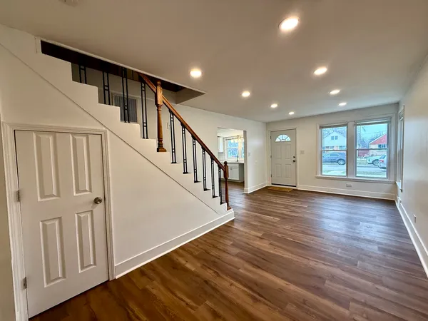 a view of an entryway with wooden floor