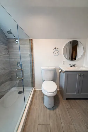 a bathroom with a toilet sink and shower