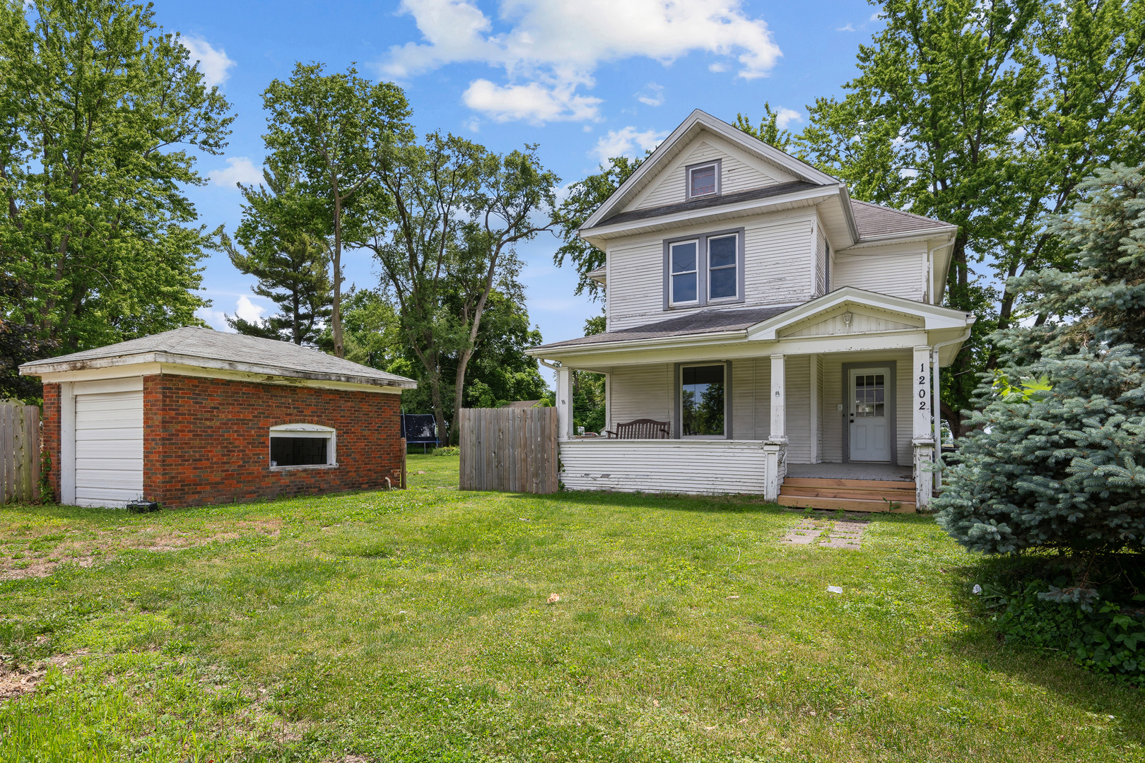 1202 20th Avenue Viola, IL 61486 - Photo 2 of 50 a front view of a house with a yard and trees