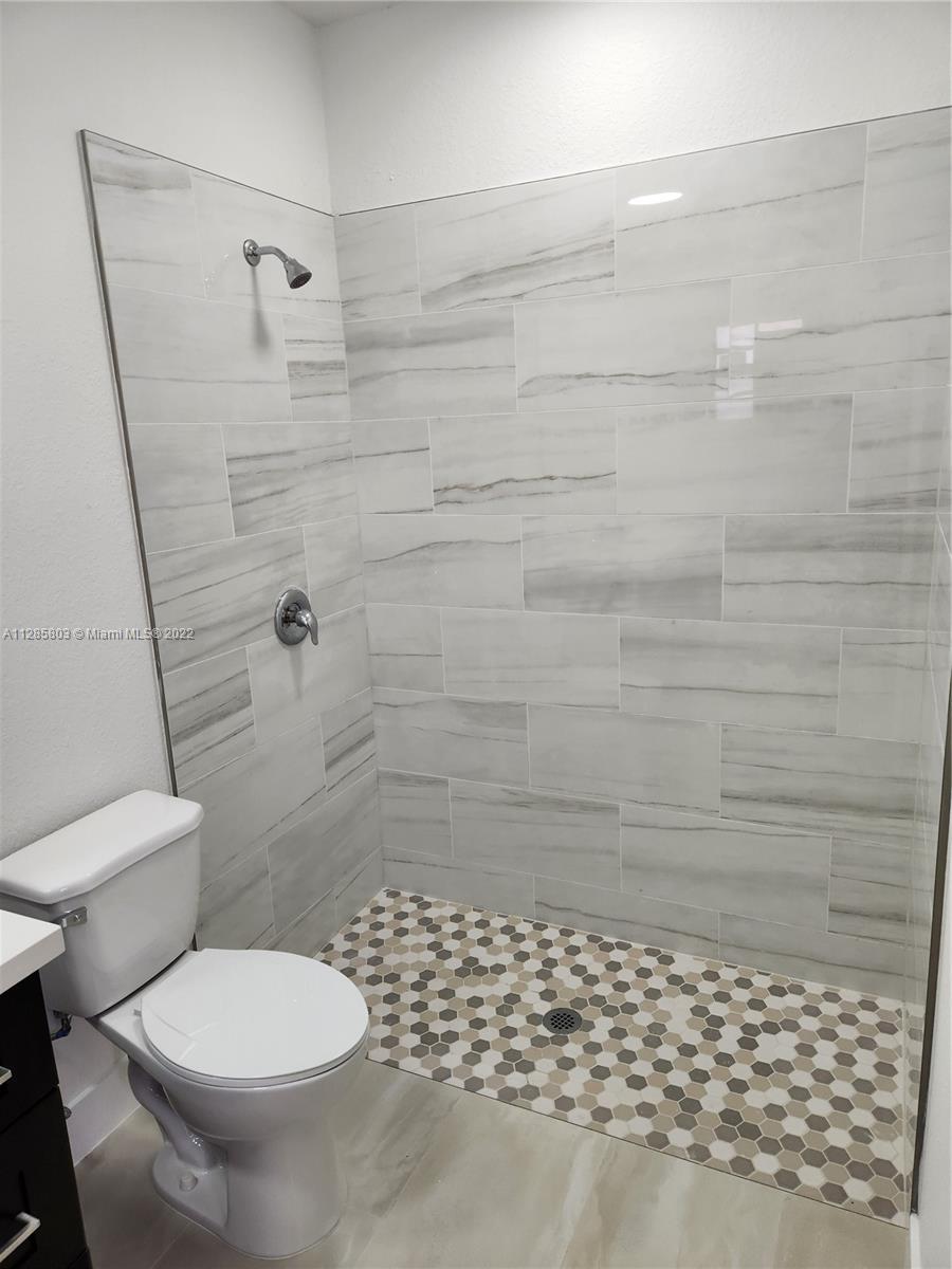 22065 Miami Avenue Miami, FL 33170 - Photo 15 of 27 a bathroom with a toilet and a shower