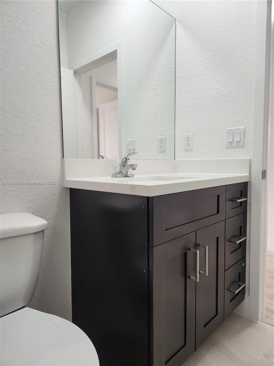 22065 Miami Avenue Miami, FL 33170 - Photo 26 of 27 a bathroom with a sink and a toilet