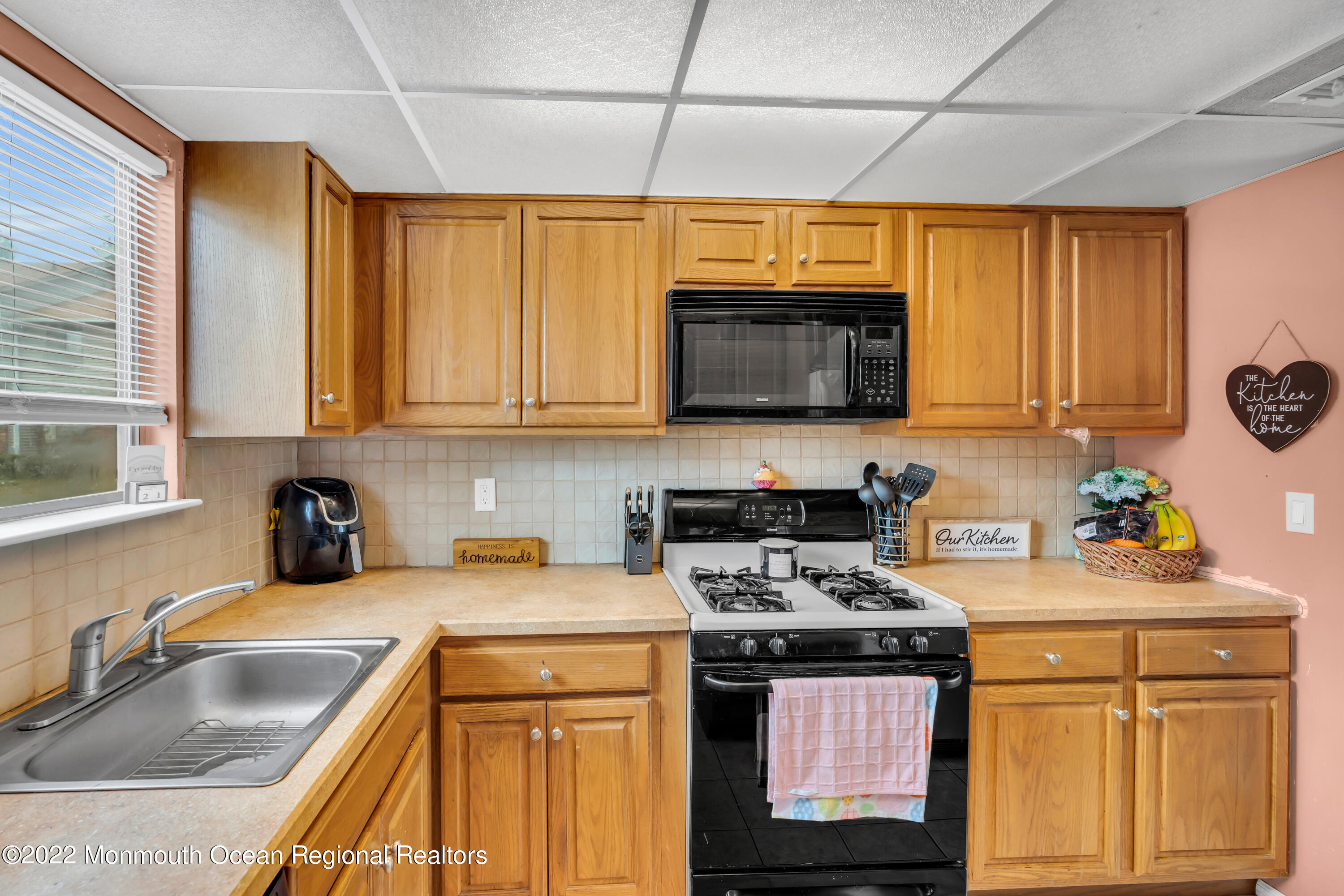 7 Jesse Drive Howell, NJ 07731 - Photo 17 of 25 a kitchen with stainless steel appliances granite countertop a sink a stove cabinets counter space and a window