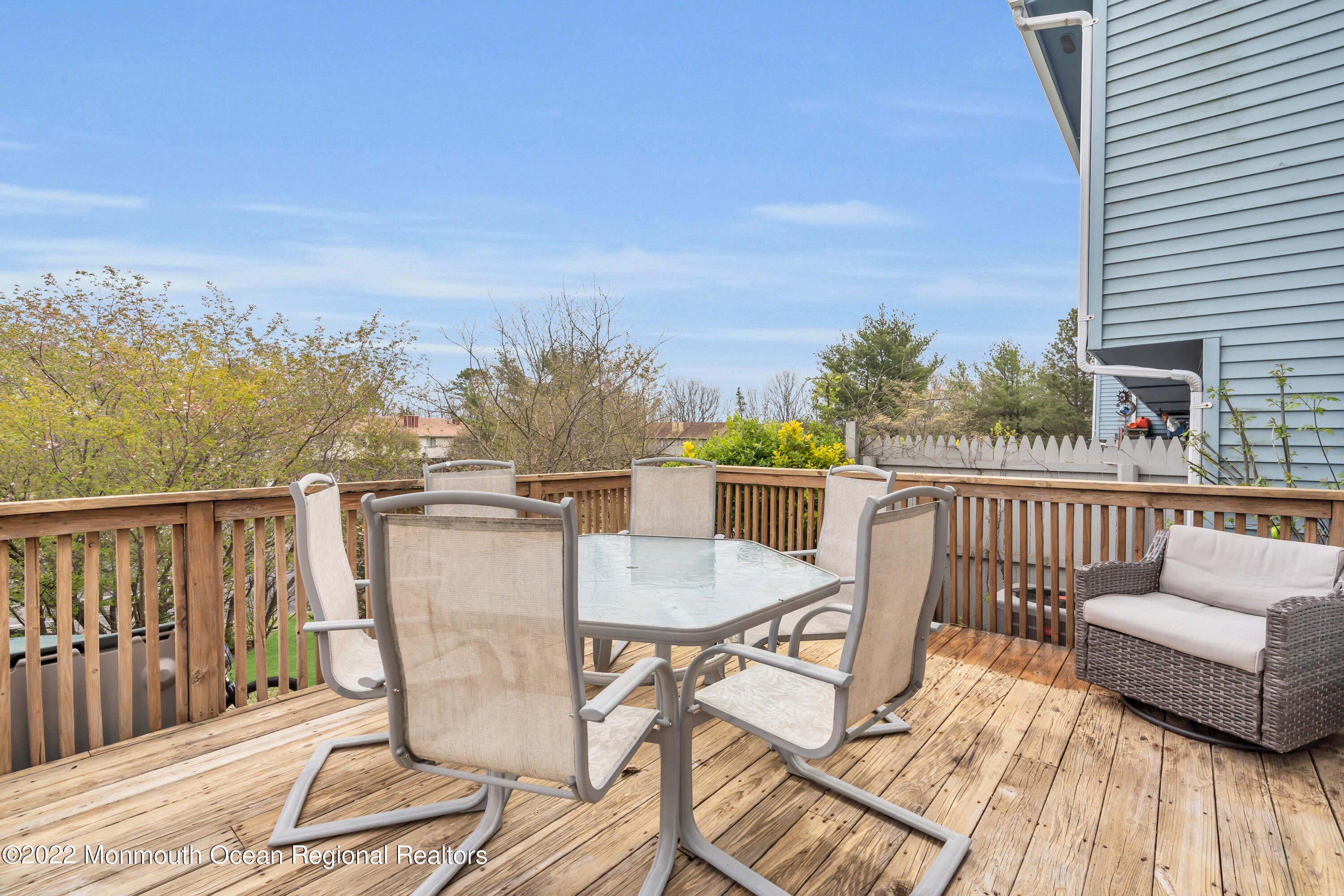 7 Jesse Drive Howell, NJ 07731 - Photo 23 of 25 a balcony with wooden floor table and chairs