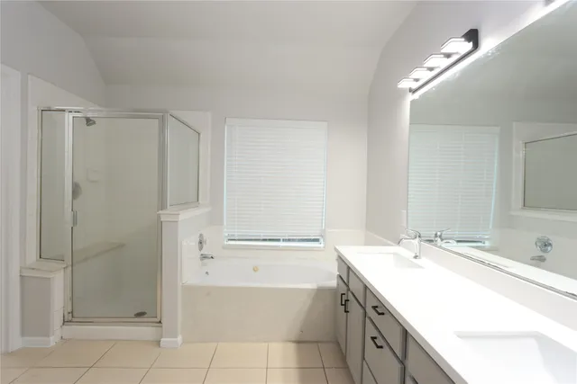 a bathroom with a granite countertop sink a toilet and shower