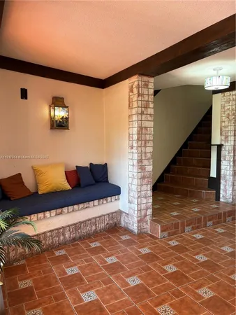 a living room with furniture and a rug