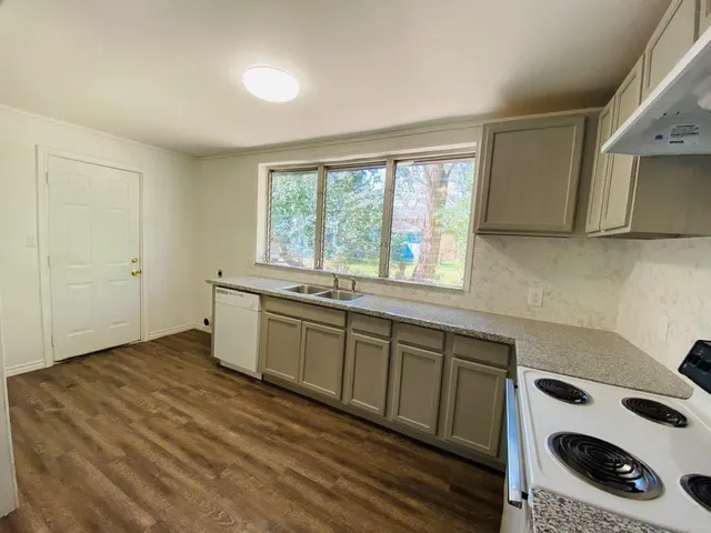 a kitchen with a sink and wooden cabinets