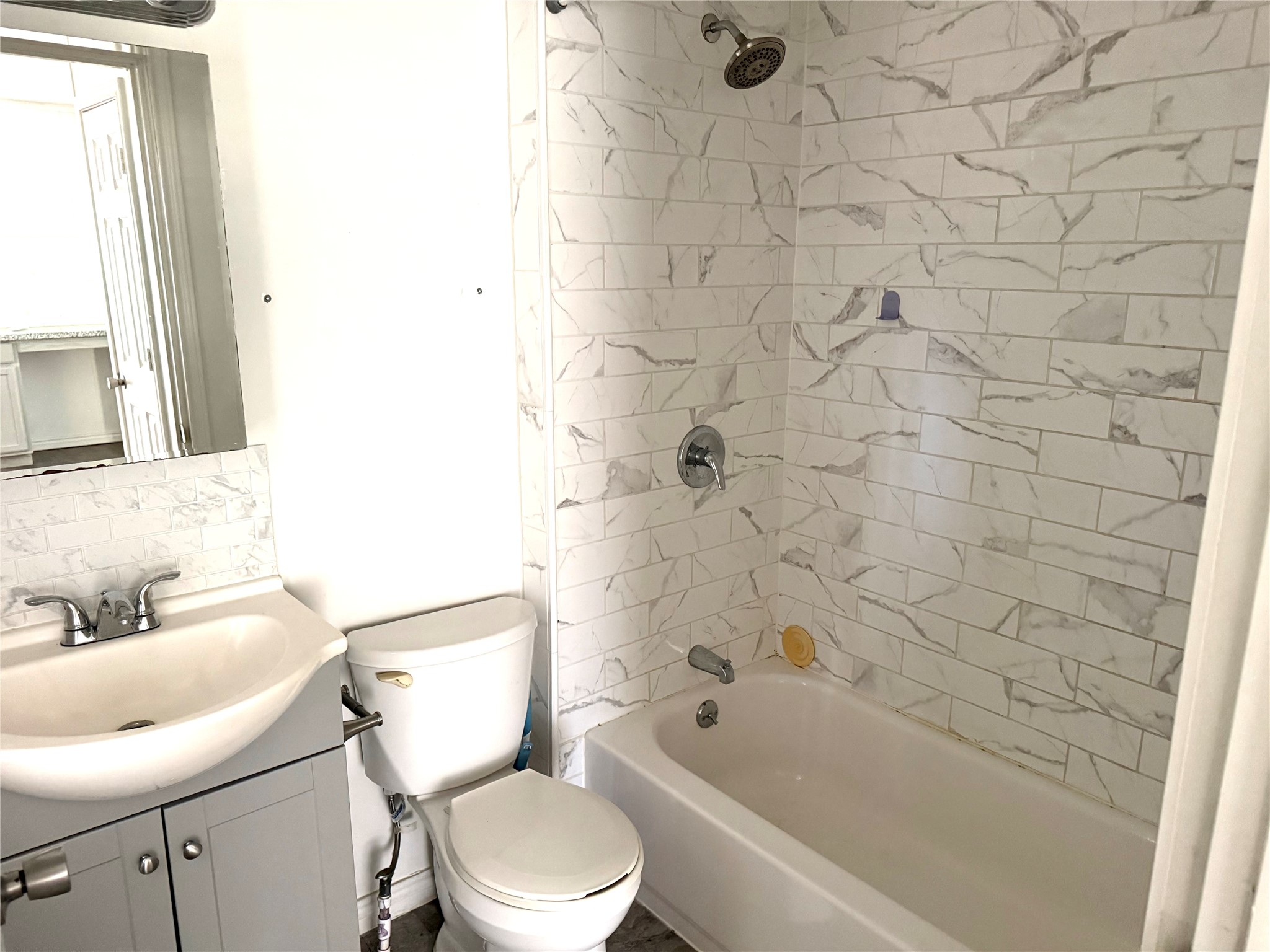 4730 Oleander Street Bacliff, TX 77518 - Photo 17 of 18 a bathroom with a toilet a sink and bathtub