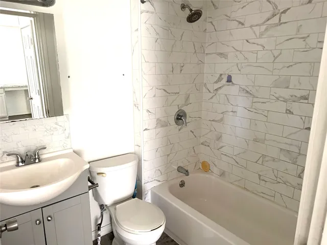 a bathroom with a toilet a sink and bathtub