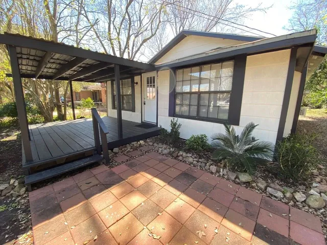 a view of a porch with furniture and backyard