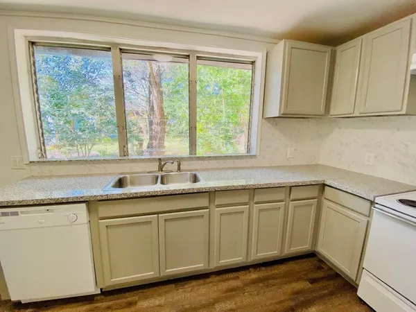 a kitchen with sink cabinets and wooden floor