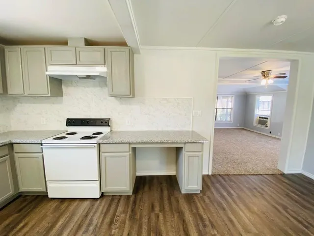 a kitchen with a sink and a stove top oven