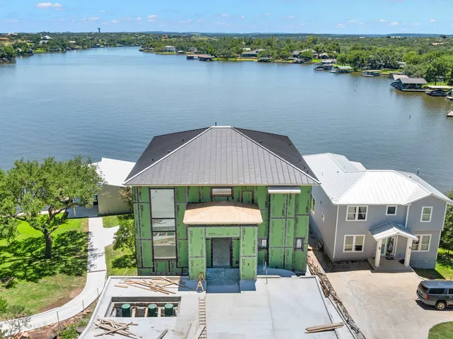 an aerial view of a house with a lake view