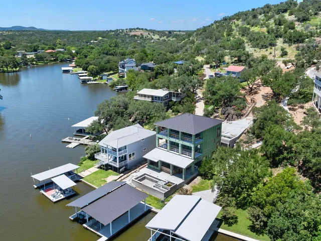 an aerial view of a house with outdoor space and lake view